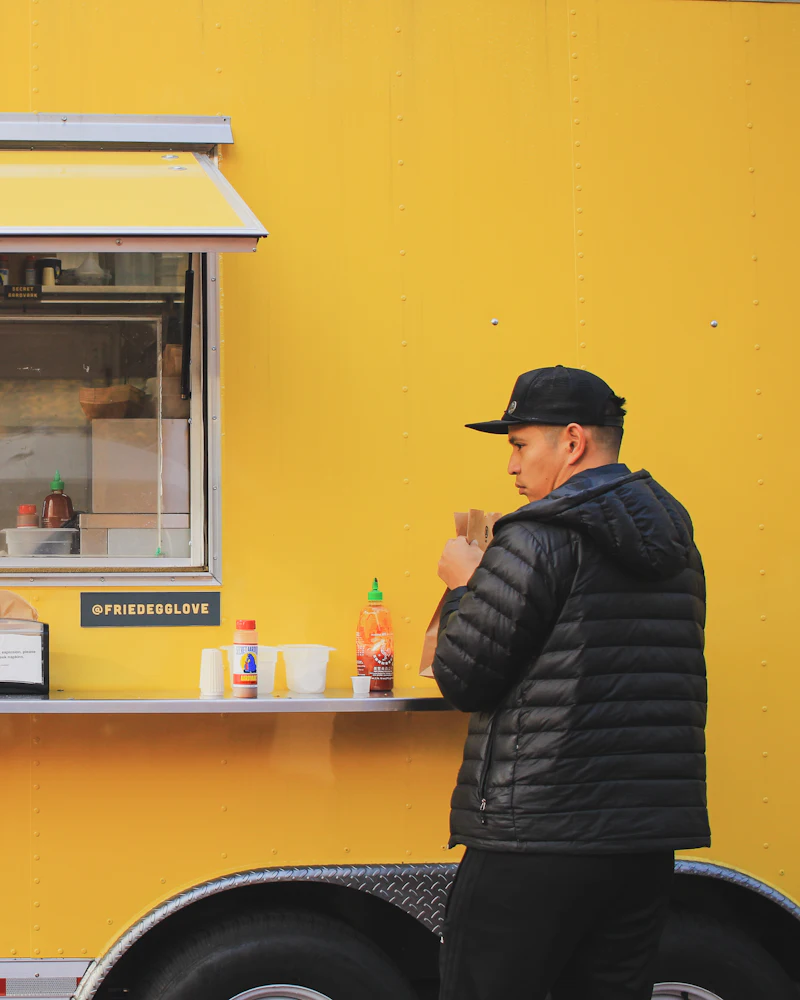 Bright yellow food truck serving customers