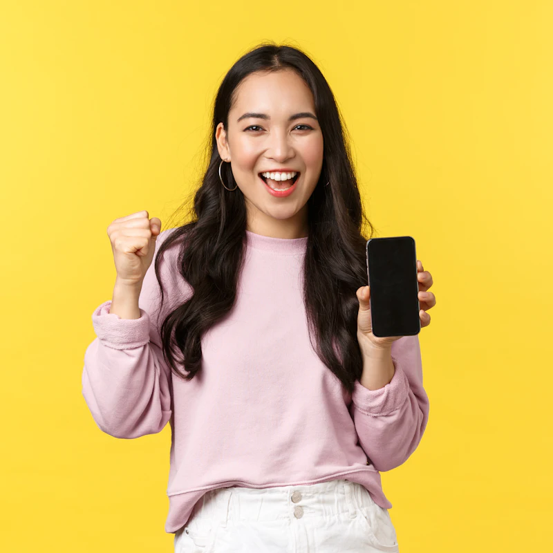 Happy Australian business owner celebrating her approved business loan on her phone